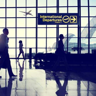 Silhouette of people in airport moving toward international departures area